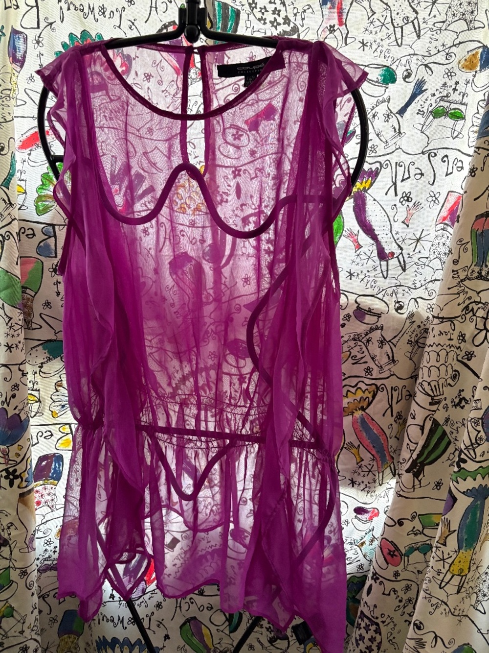 Coupe 100% poly sheer blouse with uneven hem